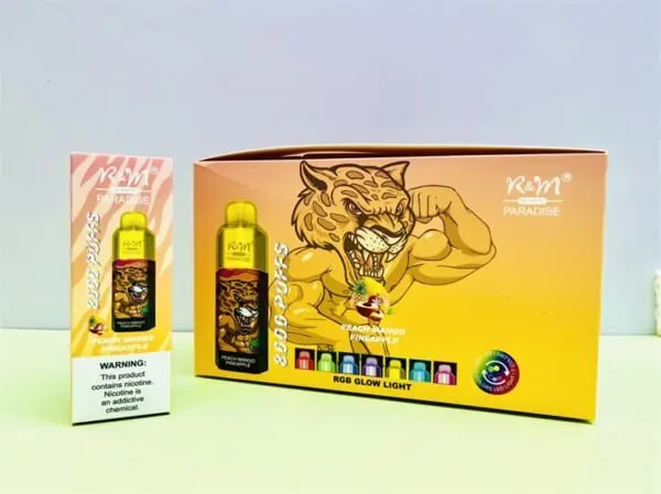 R&M Paradise vape packaging featuring a flexing tiger illustration, "Peach Mango Pineapple" flavor text, RGB glow light icons, and a warning label, displayed with a vape device and matching box.