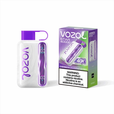A white VOZOL disposable vape with a purple cap and purple side panel sits beside its purple-to-green box labeled VOZOL Star 40000 with the flavor Cherimoya Grapefruit Berries and a nicotine warning.