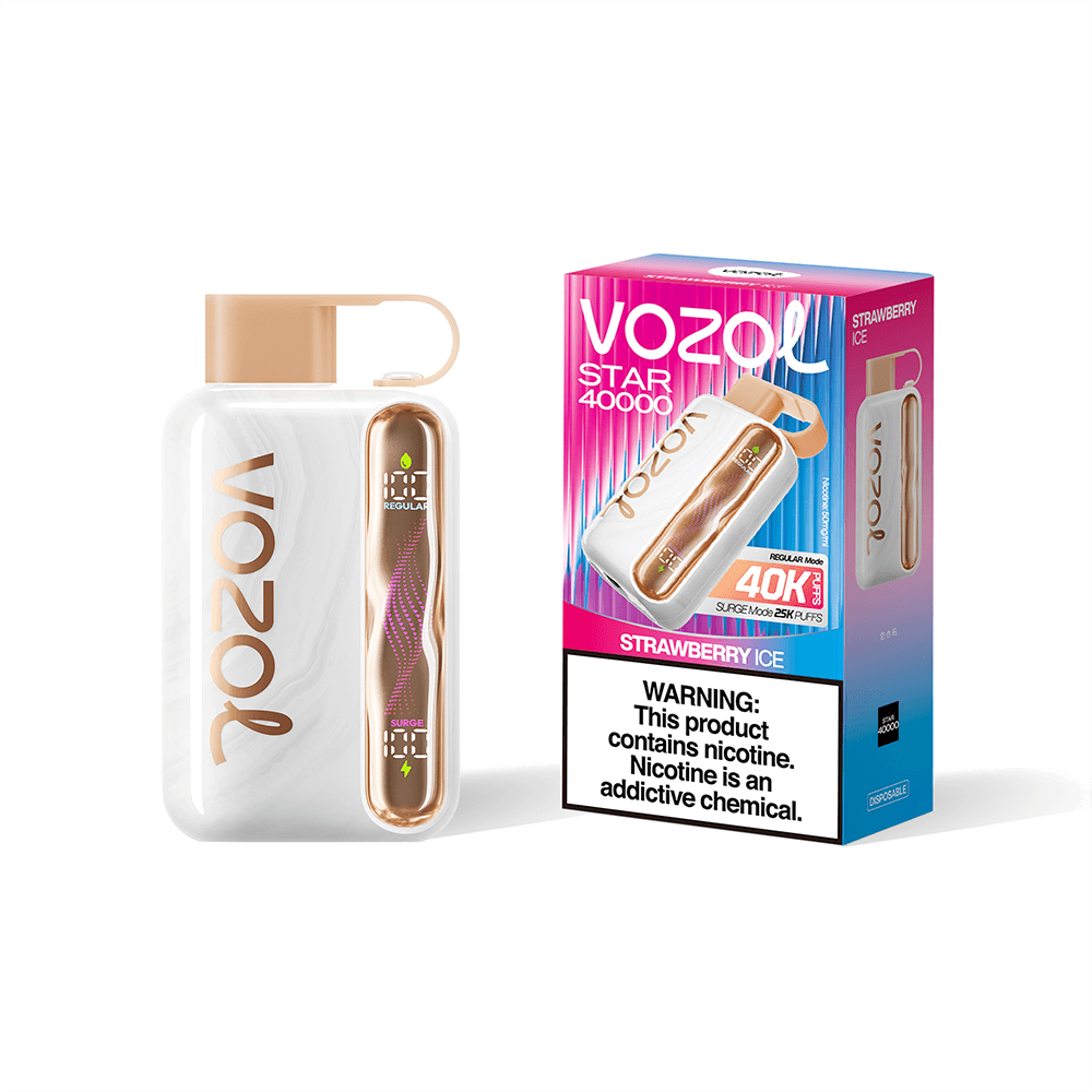 A VOZO strawberry ice disposable vape beside its bright pink packaging: a white device with a tan cap and a gold-toned cartridge, next to a VOZO box featuring the logo and a nicotine warning.