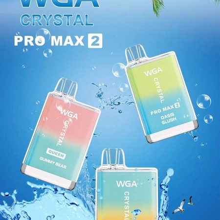 Three colorful vape devices labeled WGA Crystal Pro Max 2, floating on a splash of water with palm leaves and a blue sky background.